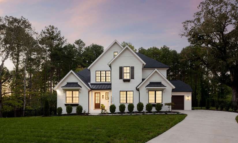A Carolina home at twilight with lit windows